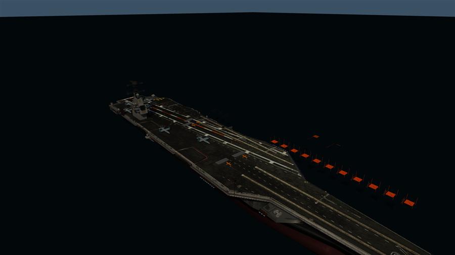 The carrier at close range, deck lit